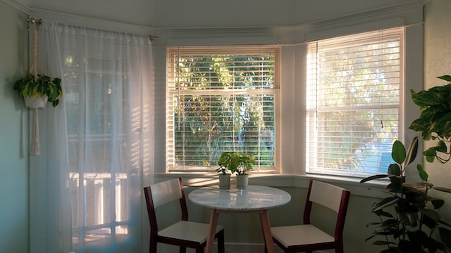 white table on the background of a window with blinds