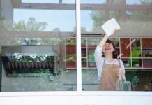 a-woman-in-an-apron-cleaning-the-window