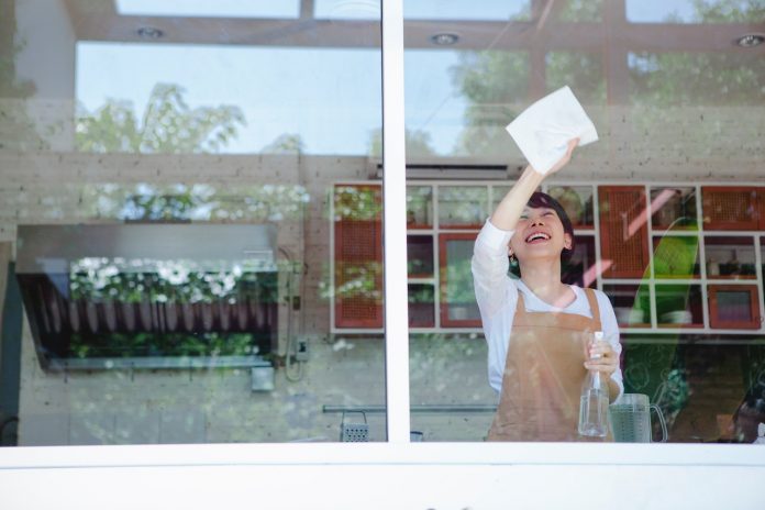 a-woman-in-an-apron-cleaning-the-window