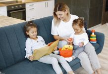 girl-reading-a-book-beside-her-mother