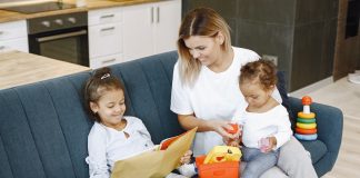 girl-reading-a-book-beside-her-mother