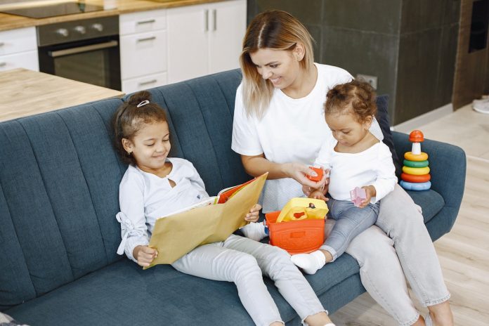 girl-reading-a-book-beside-her-mother