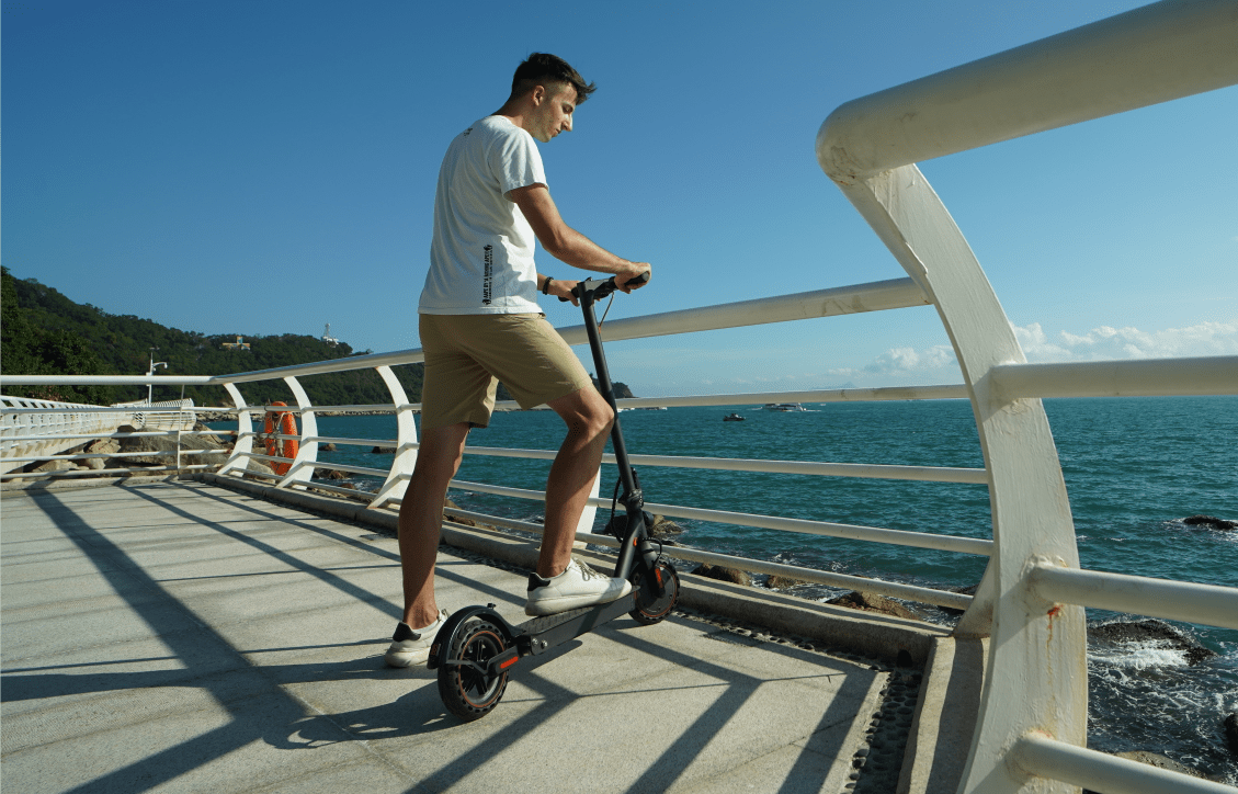 person on scooter near the sea