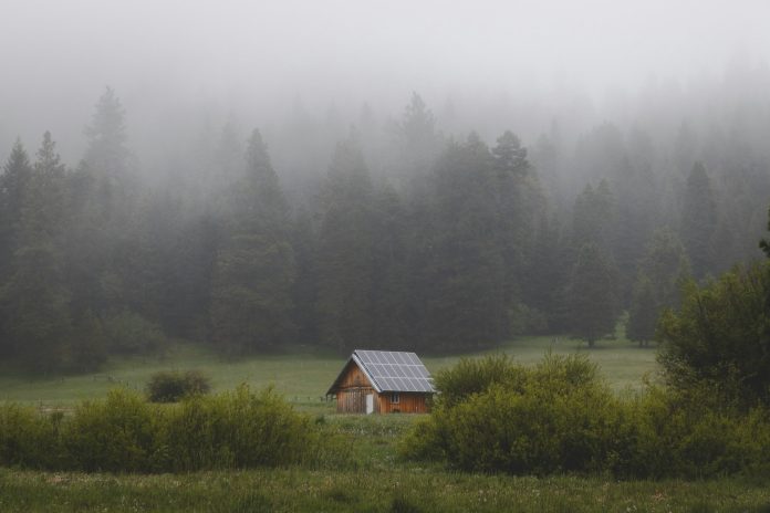 forest house with solar panels