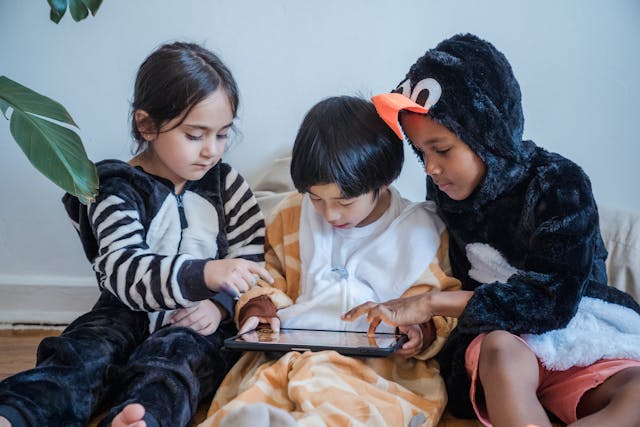 kids-in-costumes-playing-games-with-tablet-computer